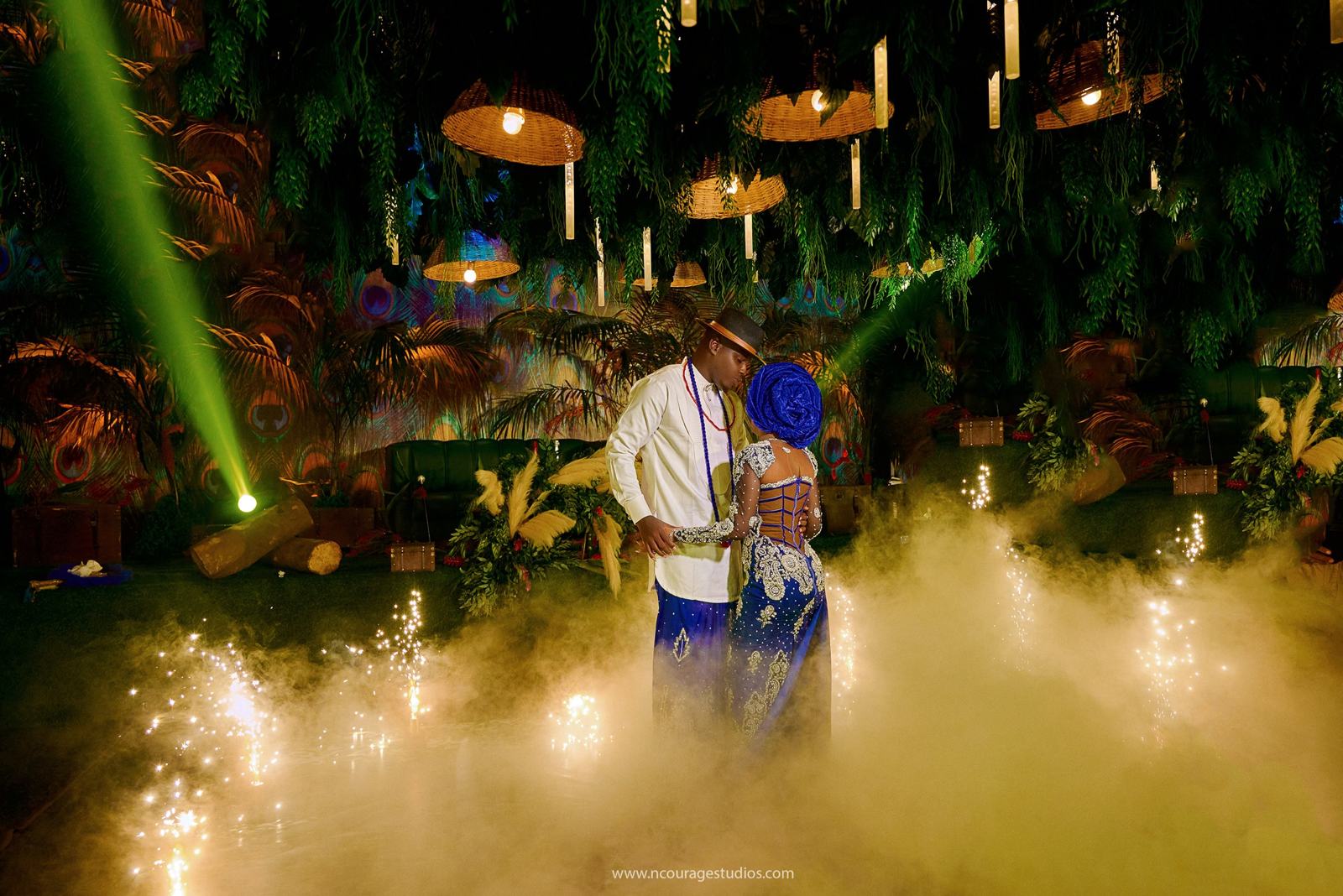 Couple dancing through fog and sparklers at a wedding